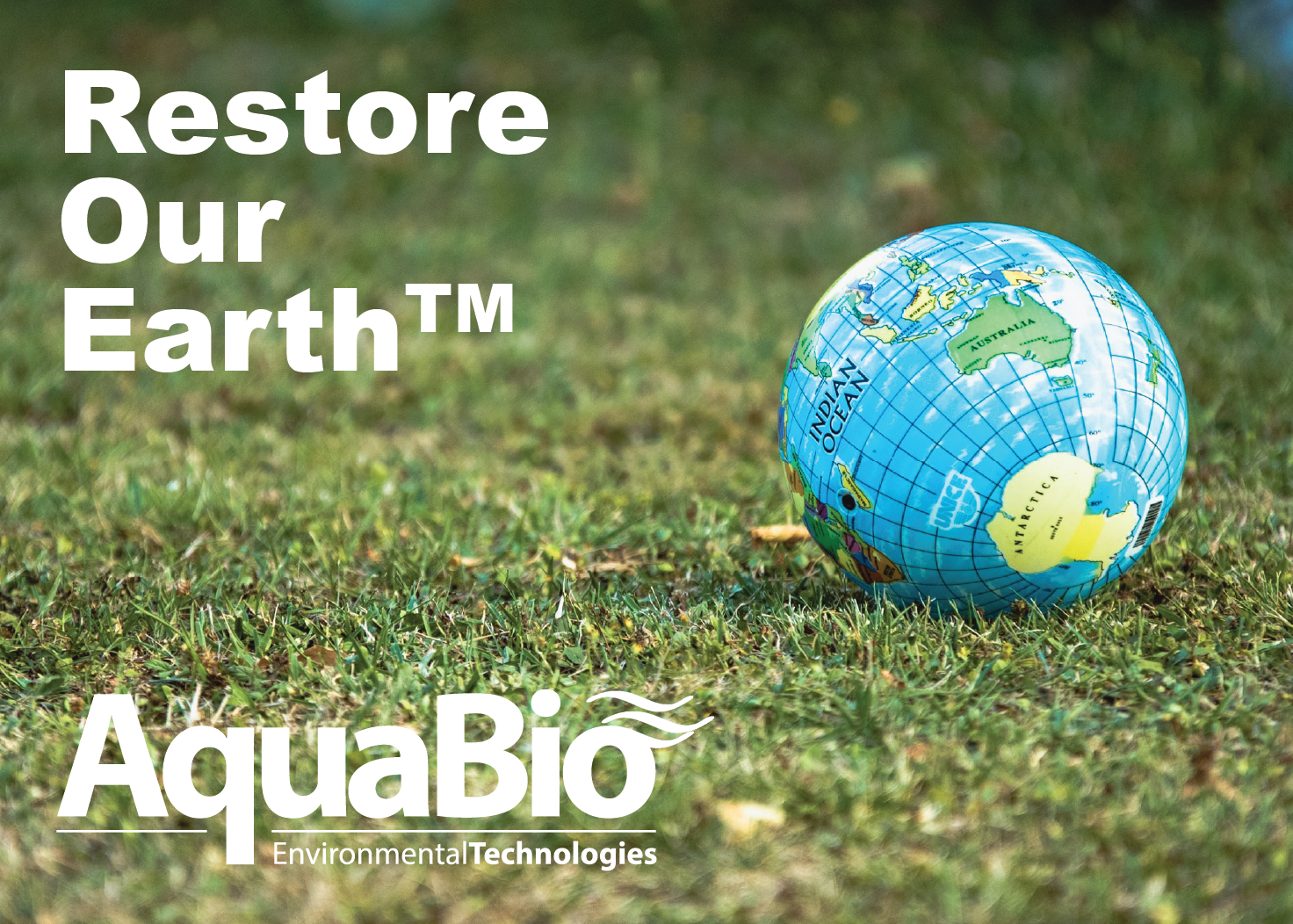 Restore Our Earth graphic showing globe resting on green lawn